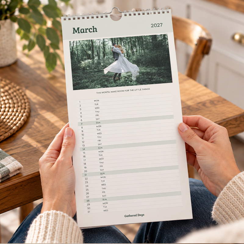 Personalised kitchen calendar being held and viewed