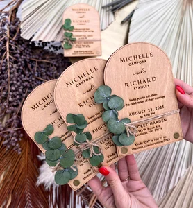 Arch shaped birch wood wedding invitation with preserved eucalyptus embellishment and engraved names